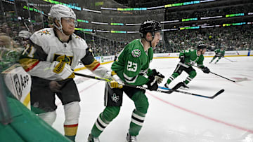May 5, 2024; Dallas, Texas, USA; Vegas Golden Knights center William Karlsson (71) and Dallas Stars defenseman Esa Lindell (23) chase the puck in the Stars zone during the third period in game seven of the first round of the 2024 Stanley Cup Playoffs at American Airlines Center. Mandatory Credit: Jerome Miron-Imagn Images