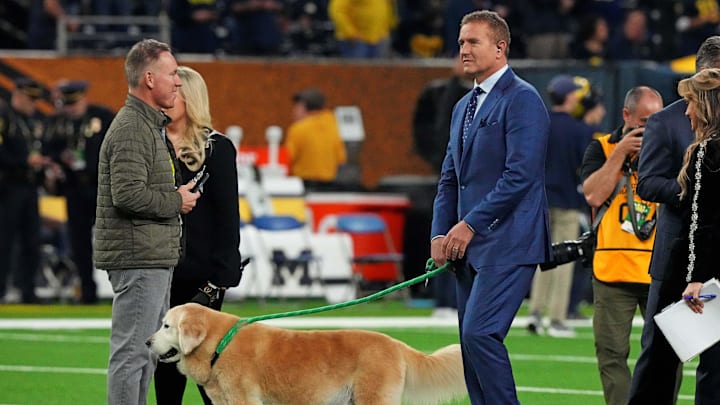 Jan 8, 2024; Houston, TX, USA; ESPN analyst  Kirk Herbstreit walks his dog Ben before the 2024 College Football Playoff national championship game between the Michigan Wolverines and the Washington Huskies at NRG Stadium. Mandatory Credit: Kirby Lee-Imagn Images