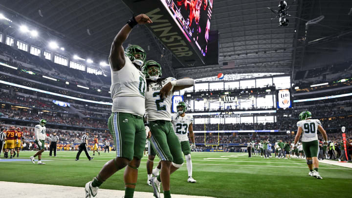 Jan 2, 2023; Arlington, Texas, USA; Tulane Green Wave defensive lineman Patrick Jenkins (0) and linebacker Dorian Williams (2) celebrate during the game between the USC Trojans and the Tulane Green Wave in the 2023 Cotton Bowl at AT&T Stadium.