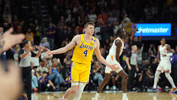 Oct 17, 2024; Phoenix, Arizona, USA; Los Angeles Lakers guard Dalton Knecht (4) reacts after making a three point basket against the Phoenix Suns during the overtime period at Footprint Center. Mandatory Credit: Joe Camporeale-Imagn Images