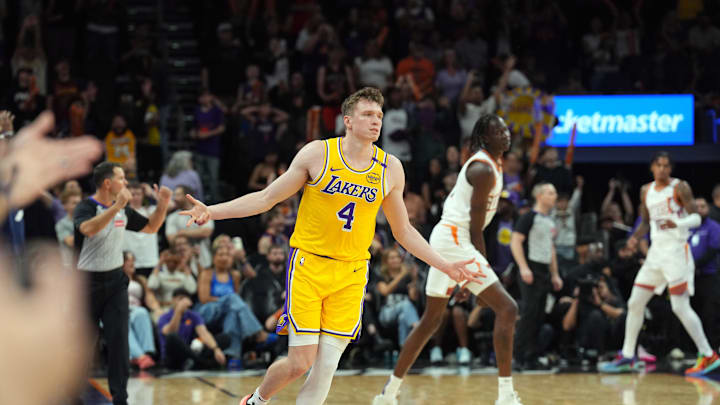 Oct 17, 2024; Phoenix, Arizona, USA; Los Angeles Lakers guard Dalton Knecht (4) reacts after making a three point basket against the Phoenix Suns during the overtime period at Footprint Center. Mandatory Credit: Joe Camporeale-Imagn Images