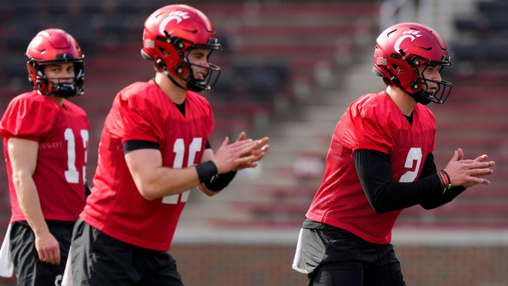 Cincinnati Bearcats quarterbacks Brady Lichtenberg and Brendan Sorsby take snaps during spring football practice, Monday, March 4, 2024, at Nippert Stadium in Cincinnati.