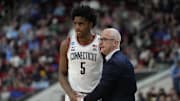 Mar 21, 2025; Raleigh, NC, USA;  Connecticut Huskies head coach Dan Hurley with center Tarris Reed Jr. (5) during the second half against the Oklahoma Sooners at Lenovo Center. Mandatory Credit: Bob Donnan-Imagn Images