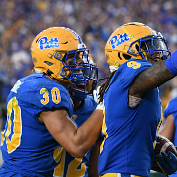 Sep 14, 2024; Pittsburgh, Pennsylvania, USA; Pittsburgh Panthers linebacker Kyle Louis celebrates with Brandon George (30) after intercepting West Virginia Mountaineers quarterback Garrett Greene (6) in the fourth quarter at Acrisure Stadium. Mandatory Credit: Barry Reeger-Image Images