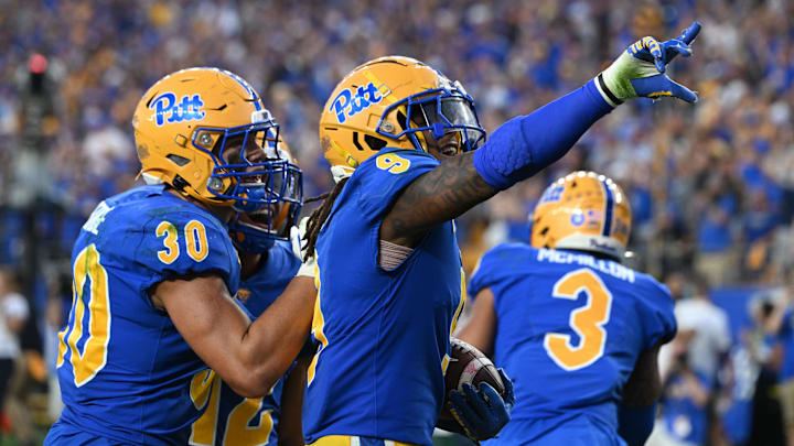 Sep 14, 2024; Pittsburgh, Pennsylvania, USA; Pittsburgh Panthers linebacker Kyle Louis celebrates with Brandon George (30) after intercepting West Virginia Mountaineers quarterback Garrett Greene (6) in the fourth quarter at Acrisure Stadium. Mandatory Credit: Barry Reeger-Image Images