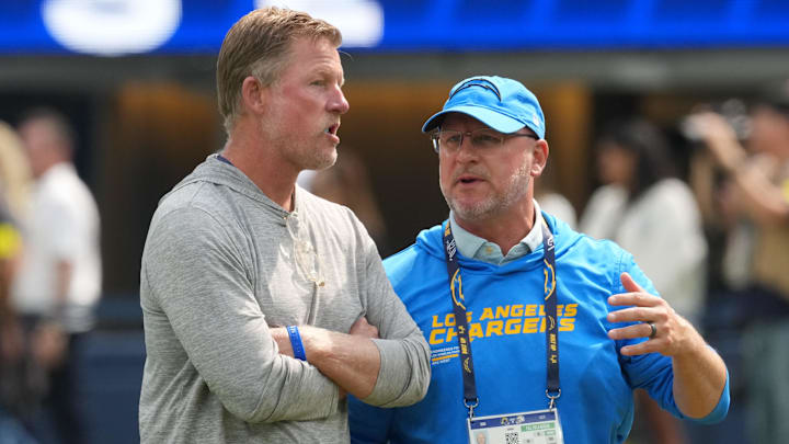 Aug 16, 2025; Inglewood, California, USA; Los Angeles Rams general manager Les Snead (left) talks with Los Angeles Chargers general manager Joe Hortiz at SoFi Stadium. Mandatory Credit: Kirby Lee-Imagn Images
