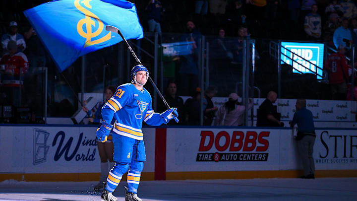 Mar 24, 2026; St. Louis, Missouri, USA; St. Louis Blues right wing Jimmy Snuggerud (21) salutes the fans after he was named second star of the game after a victory over the Washington Capitals at Enterprise Center. Mandatory Credit: Jeff Curry-Imagn Images