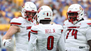 Sep 27, 2025; Pittsburgh, Pennsylvania, USA;  Louisville Cardinals wide receiver Chris Bell (0) celebrates his touchdown with tight end Nate Kurisky (85) and offensive lineman Jordan Church (74) against the Pittsburgh Panthers during the second quarter at Acrisure Stadium. Mandatory Credit: Charles LeClaire-Imagn Images