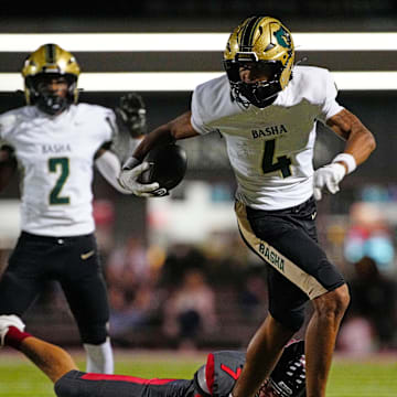 Basha wide receiver Kash Brock (4) breaks a tackle against Williams Field defensive back Bryson Raspberry (7) on his way to a touchdown during a game at Williams Field High School in Gilbert, on Sept. 12, 2025.