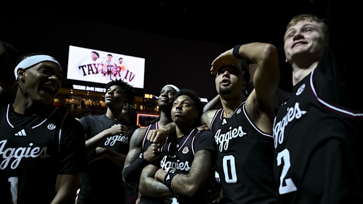 Mar 4, 2025; College Station, Texas, USA; Texas A&M Aggies guard Wade Taylor IV (4) watches with teammates during his retired jersey is revealed after the game against the Auburn Tigers at Reed Arena. Mandatory Credit: Maria Lysaker-Imagn Images 