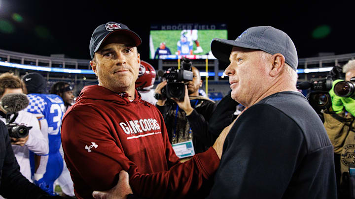 Oct 8, 2022; Lexington, Kentucky, USA; South Carolina Gamecocks head coach Shane Beamer and Kentucky Wildcats head coach Mark Stoops shake hands after a game at Kroger Field. Mandatory Credit: Jordan Prather-Imagn Images