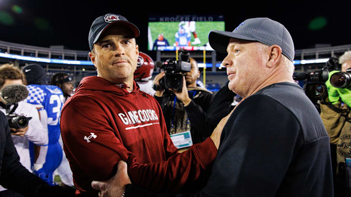 Oct 8, 2022; Lexington, Kentucky, USA; South Carolina Gamecocks head coach Shane Beamer and Kentucky Wildcats head coach Mark Stoops shake hands after a game at Kroger Field. Mandatory Credit: Jordan Prather-Imagn Images