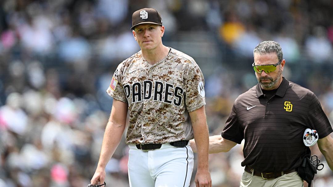 Apr 12, 2026; San Diego, California, USA; San Diego Padres starting pitcher Nick Pivetta (27), left, leaves the field with a trainer during the fourth inning against the Colorado Rockies at Petco Park. Mandatory Credit: Denis Poroy-Imagn Images