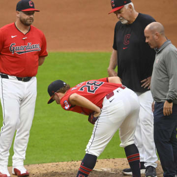 Jul 24, 2024; Cleveland, Ohio, USA; Cleveland Guardians starting pitcher Tanner Bibee (28) stretches beside manager Stephen Vogt (12) and pitching coach Carl Willis (51) before leaving the game in the fifth inning against the Detroit Tigers at Progressive Field. Mandatory Credit: David Richard-USA TODAY Sports