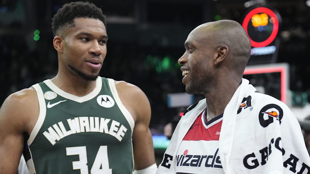 Oct 22, 2025; Milwaukee, Wisconsin, USA; Milwaukee Bucks forward Giannis Antetokounmpo (34) and Washington Wizards forward Khris Middleton (22) former teammates talk to each other after their game at Fiserv Forum. Mandatory Credit: Michael McLoone-Imagn Images