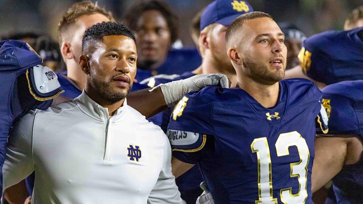 Sep 20, 2025; South Bend, Indiana, USA; Notre Dame Fighting Irish head coach Marcus Freeman and quarterback CJ Carr (13) sing the alma mater after beating the Purdue Boilermakers at Notre Dame Stadium. Mandatory Credit: Michael Caterina-Imagn Images