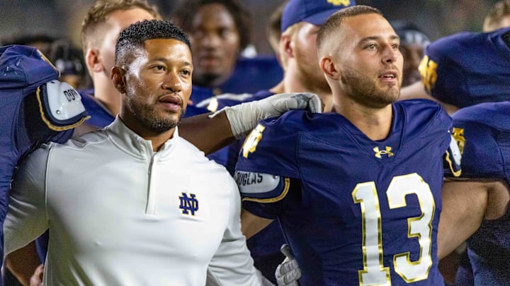 Sep 20, 2025; South Bend, Indiana, USA; Notre Dame Fighting Irish head coach Marcus Freeman and quarterback CJ Carr (13) sing the alma mater after beating the Purdue Boilermakers at Notre Dame Stadium. Mandatory Credit: Michael Caterina-Imagn Images