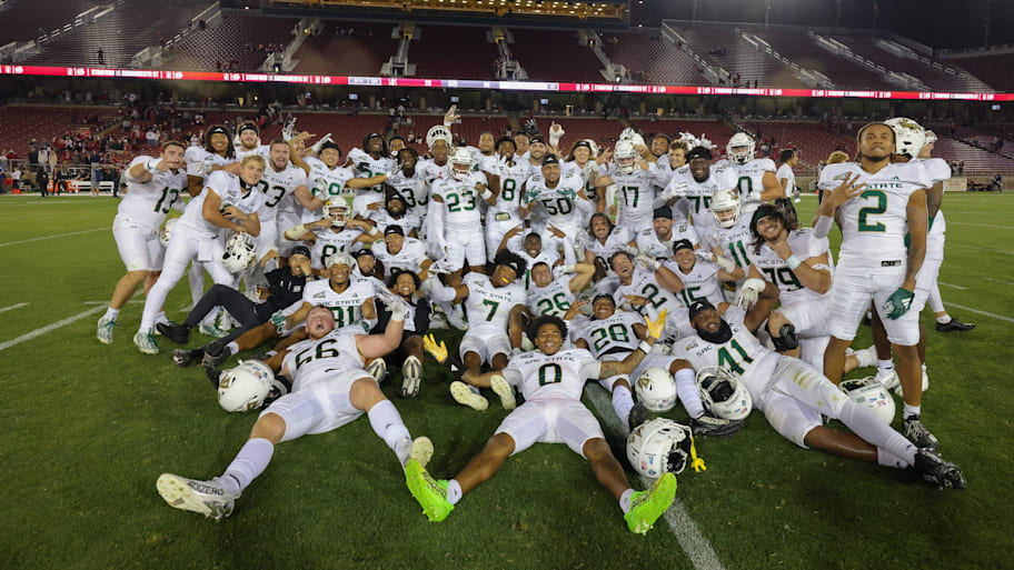 Sacramento State football players pose for a photo after a game.