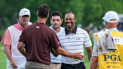 Tiger Woods smiles after finishing his round of golf with golfers Adam Scott and Keegan Bradley at the 18th green late Friday at the 2024 PGA Championship second round at Valhalla Golf Course in Louisville, Kentucky. May 17, 2024. The 15-time major champion Woods missed the cut -- finishing 72 and 77 for his two rounds.