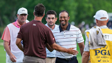 Tiger Woods smiles after finishing his round of golf with golfers Adam Scott and Keegan Bradley at the 18th green late Friday at the 2024 PGA Championship second round at Valhalla Golf Course in Louisville, Kentucky. May 17, 2024. The 15-time major champion Woods missed the cut -- finishing 72 and 77 for his two rounds.