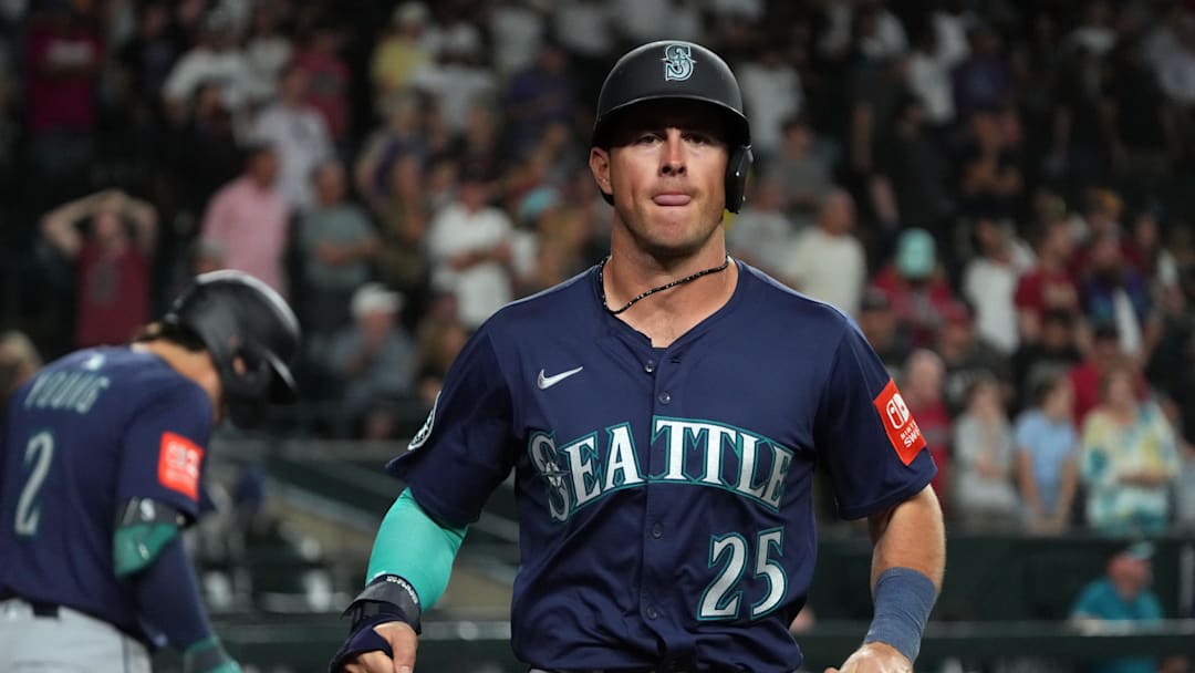 Jun 9, 2025; Phoenix, Arizona, USA; Seattle Mariners second base Dylan Moore (25) scores a run against the Arizona Diamondbacks in the ninth inning at Chase Field. Mandatory Credit: Rick Scuteri-Imagn Images