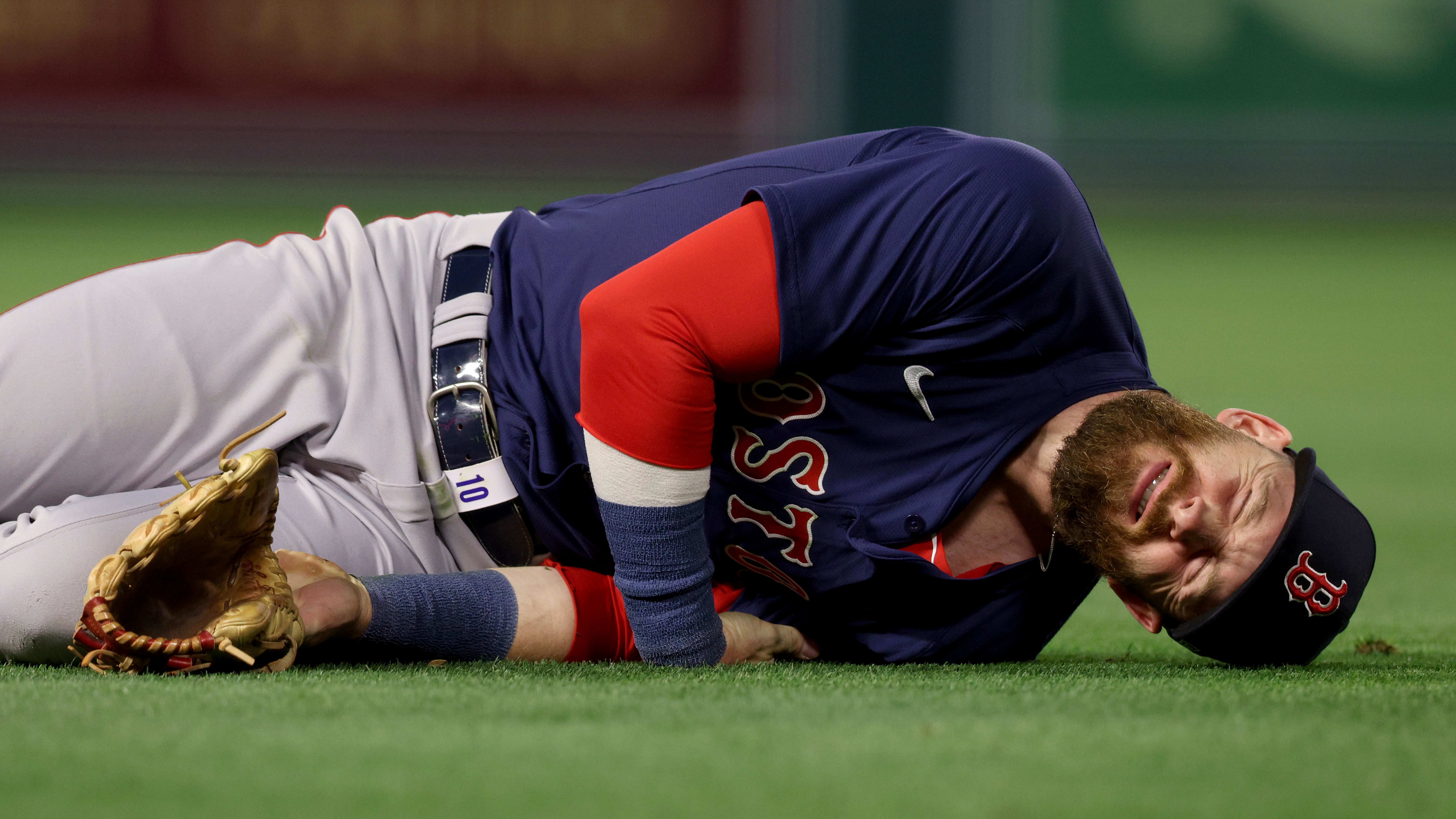 Apr 5, 2024; Anaheim, California, USA; Boston Red Sox shortstop Trevor Story (10) reacts after a shoulder injury.
