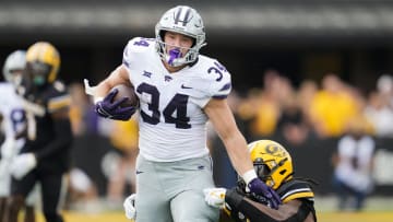 Sep 16, 2023; Columbia, Missouri, USA; Kansas State Wildcats tight end Ben Sinnott (34) runs with the ball against Missouri Tigers linebacker Ty'Ron Hopper (8) during the first half at Faurot Field at Memorial Stadium. Mandatory Credit: Jay Biggerstaff-USA TODAY Sports