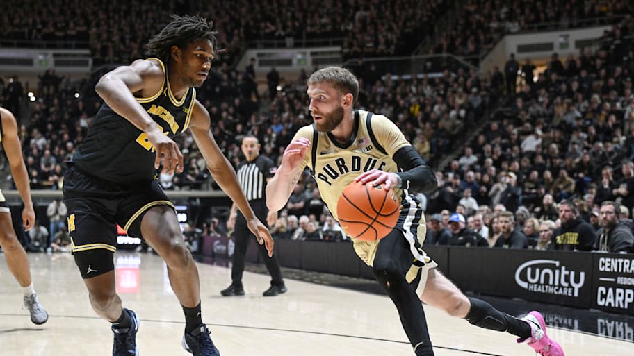 Purdue guard Braden Smith drives the ball past Michigan forward Morez Johnson Jr.