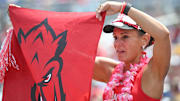 An Arkansas Razorbacks fan holds a flag during the game against the Murray State Racers at Charles Schwab Field. 