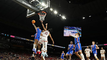 Apr 5, 2025; San Antonio, TX, USA; Florida Gators guard Alijah Martin (15) dunks the ball against Auburn Tigers guard Tahaad Pettiford (0) and guard Chad Baker-Mazara (10) during the second half in the semifinals of the men's Final Four of the 2025 NCAA Tournament at the Alamodome. Mandatory Credit: Bob Donnan-Imagn Images