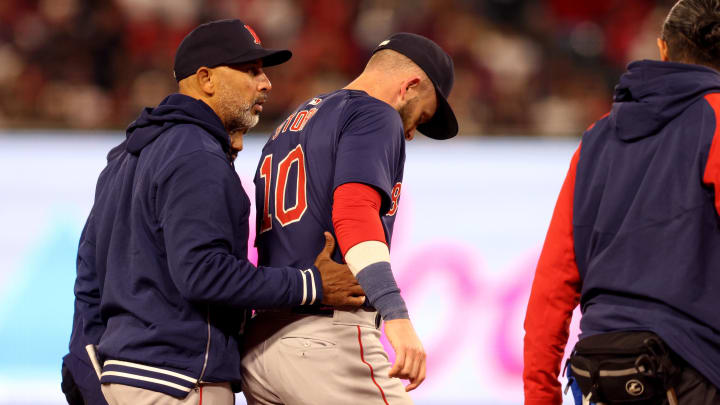 Apr 5, 2024; Anaheim, California, USA; Boston Red Sox manager Alex Cora (13) talks to shortstop Trevor Story (10) after an injury during the fourth inning against the Los Angeles Angels at Angel Stadium. Mandatory Credit: Jason Parkhurst-USA TODAY Sports