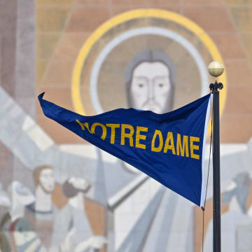 Nov 19, 2022; South Bend, Indiana, USA; A Notre Dame pennant flies in front of the Word of Life Mural, commonly known as Touchdown Jesus, before the game between the Notre Dame Fighting Irish and the Boston College Eagles at Notre Dame Stadium. 