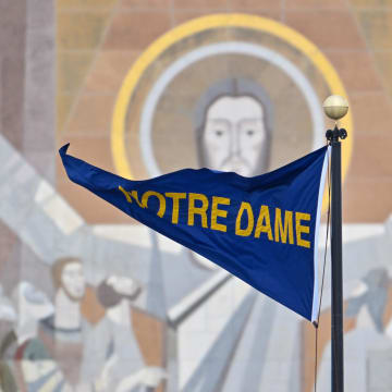 Nov 19, 2022; South Bend, Indiana, USA; A Notre Dame pennant flies in front of the Word of Life Mural, commonly known as Touchdown Jesus, before the game between the Notre Dame Fighting Irish and the Boston College Eagles at Notre Dame Stadium.