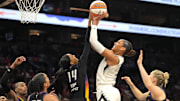 Aug 15, 2025; Phoenix, Arizona, USA; Las Vegas Aces center A'ja Wilson (22) shoots over Phoenix Mercury guard Kahleah Copper (2), forward Alyssa Thomas (25), forward DeWanna Bonner (14), and guard Sami Whitcomb (33) in the first half at Footprint Center. Mandatory Credit: Rick Scuteri-Imagn Images