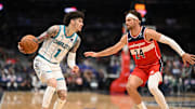 Oct 26, 2025; Washington, District of Columbia, USA; Charlotte Hornets guard LaMelo Ball (1) attempts to drive past Washington Wizards forward Corey Kispert (24) during the third quarter at Capital One Arena. Mandatory Credit: Rafael Suanes-Imagn Images