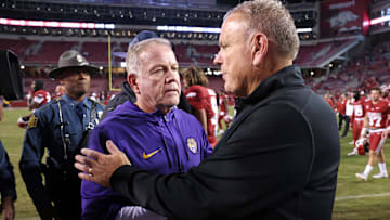 Oct 19, 2024; Fayetteville, Arkansas, USA; LSU Tigers head coach Brian Kelly shakes hands with Arkansas Razorbacks head coach Sam Pittman after a game at Donald W. Reynolds Razorback Stadium. LSU won 34-10. Mandatory Credit: Nelson Chenault-Imagn Images