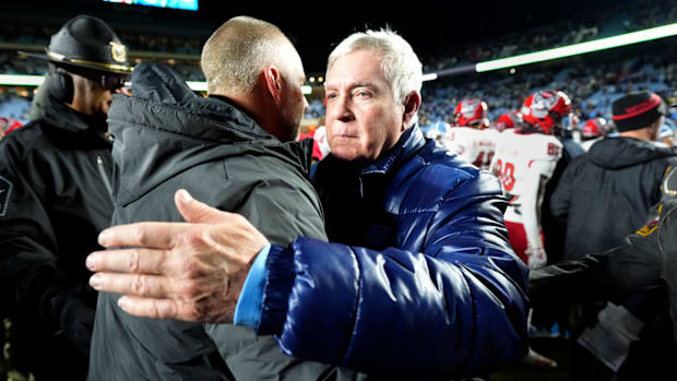 North Carolina Tar Heels head coach Mack Brown with North Carolina State Wolfpack head coach Dave Doeren after the game.