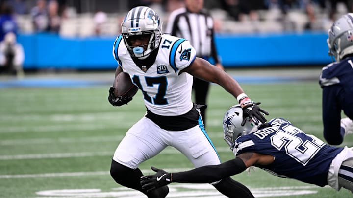 Dec 15, 2024; Charlotte, North Carolina, USA; Carolina Panthers wide receiver Xavier Legette (17) with the ball as Dallas Cowboys cornerback Amani Oruwariye (27) defefends in the first quarter at Bank of America Stadium. Mandatory Credit: Bob Donnan-Imagn Images