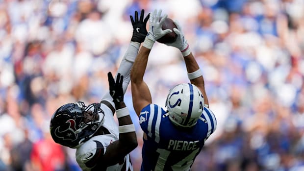 Indianapolis Colts wide receiver Alec Pierce (14) pulls in a pass while being guarded by a Houston Texans defender Sunday, Se