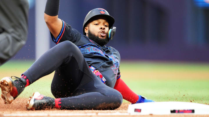 Jul 24, 2024; Toronto, Ontario, CAN; Toronto Blue Jays first base Vladimir Guerrero Jr. (27) steals third base against the Tampa Bay Rays during the first inning at Rogers Centre.