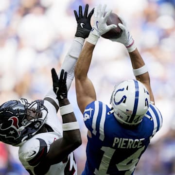 Sep 8, 2024; Indianapolis, Indiana, USA; Indianapolis Colts wide receiver Alec Pierce (14) pulls in a pass while being guarded by a Houston Texans defender Sunday, Sept. 8, 2024, during a game against the Houston Texans at Lucas Oil Stadium. Mandatory Credit: Grace Hollars/USA TODAY Network via Imagn Images