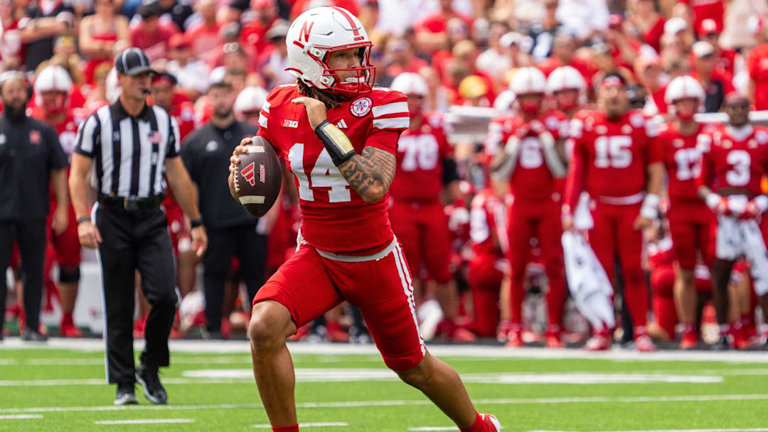Sep 13, 2025; Lincoln, Nebraska, USA; Nebraska Cornhuskers quarterback TJ Lateef (14) scrambles against the Houston Christian Huskies during the third quarter at Memorial Stadium. Mandatory Credit: Dylan Widger-Imagn Images