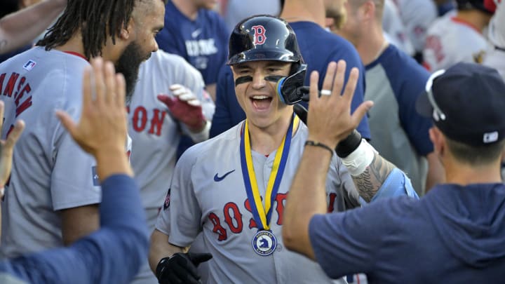 Boston Red Sox left fielder Tyler O'Neill (17) is congratulated in the dugout after hitting his second two-run home run of the game in the seventh inning against the Los Angeles Dodgers at Dodger Stadium on July 20.