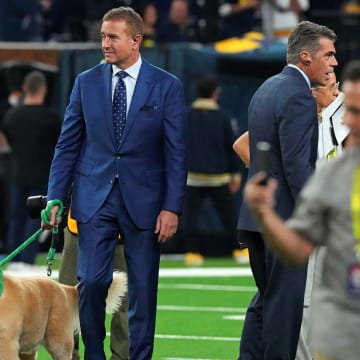 Jan 8, 2024; Houston, TX, USA; ESPN analyst  Kirk Herbstreit walks his dog Ben before the 2024 College Football Playoff national championship game between the Michigan Wolverines and the Washington Huskies at NRG Stadium.