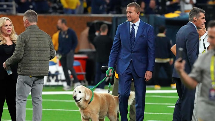 Jan 8, 2024; Houston, TX, USA; ESPN analyst  Kirk Herbstreit walks his dog Ben before the 2024 College Football Playoff national championship game between the Michigan Wolverines and the Washington Huskies at NRG Stadium.