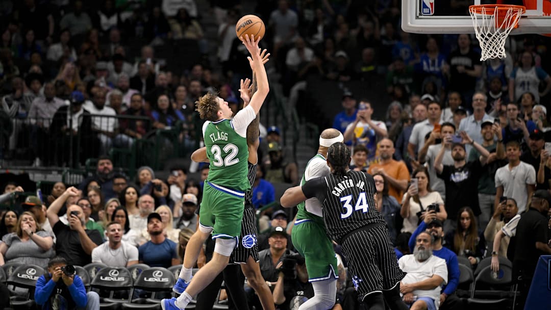 Apr 3, 2026; Dallas, Texas, USA; Dallas Mavericks forward Cooper Flagg (32) makes a jump shot over Orlando Magic forward Jamal Cain (8) for his fiftieth point of the night during the fourth quarter at the American Airlines Center. Mandatory Credit: Jerome Miron-Imagn Images