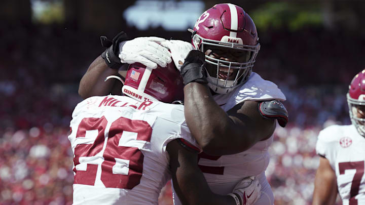 Sep 14, 2024; Madison, Wisconsin, USA;  Alabama Crimson Tide running back Jam Miller (26) is greeted by offensive lineman Tyler Booker (52) after scoring a touchdown during the third quarter against the Wisconsin Badgers at Camp Randall Stadium. Mandatory Credit: Jeff Hanisch-Imagn Images