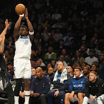 Apr 3, 2025; Brooklyn, New York, USA; Minnesota Timberwolves shooting guard Anthony Edwards (5) shoots a three point jump shot over Brooklyn Nets guard Keon Johnson (45) during the second half at Barclays Center.