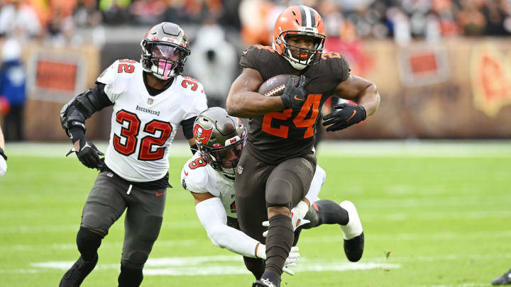 Nov 27, 2022; Cleveland, Ohio, USA; Tampa Bay Buccaneers safety Mike Edwards (32) and linebacker Joe Tryon-Shoyinka (9) chase Cleveland Browns running back Nick Chubb (24) during the first quarter at FirstEnergy Stadium. Mandatory Credit: Ken Blaze-USA TODAY Sports