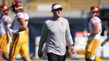Oct 28, 2023; Berkeley, California, USA; USC Trojans head coach Lincoln Riley (center) walks on the field before the game against the California Golden Bears at California Memorial Stadium. Mandatory Credit: Darren Yamashita-Imagn Images